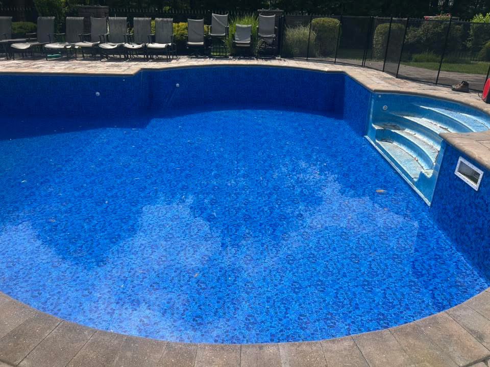 Gorgeous new blue liner with steps in paver-deck pool