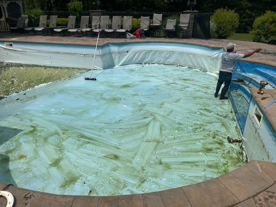 Old liner being stripped from upscale inground pool