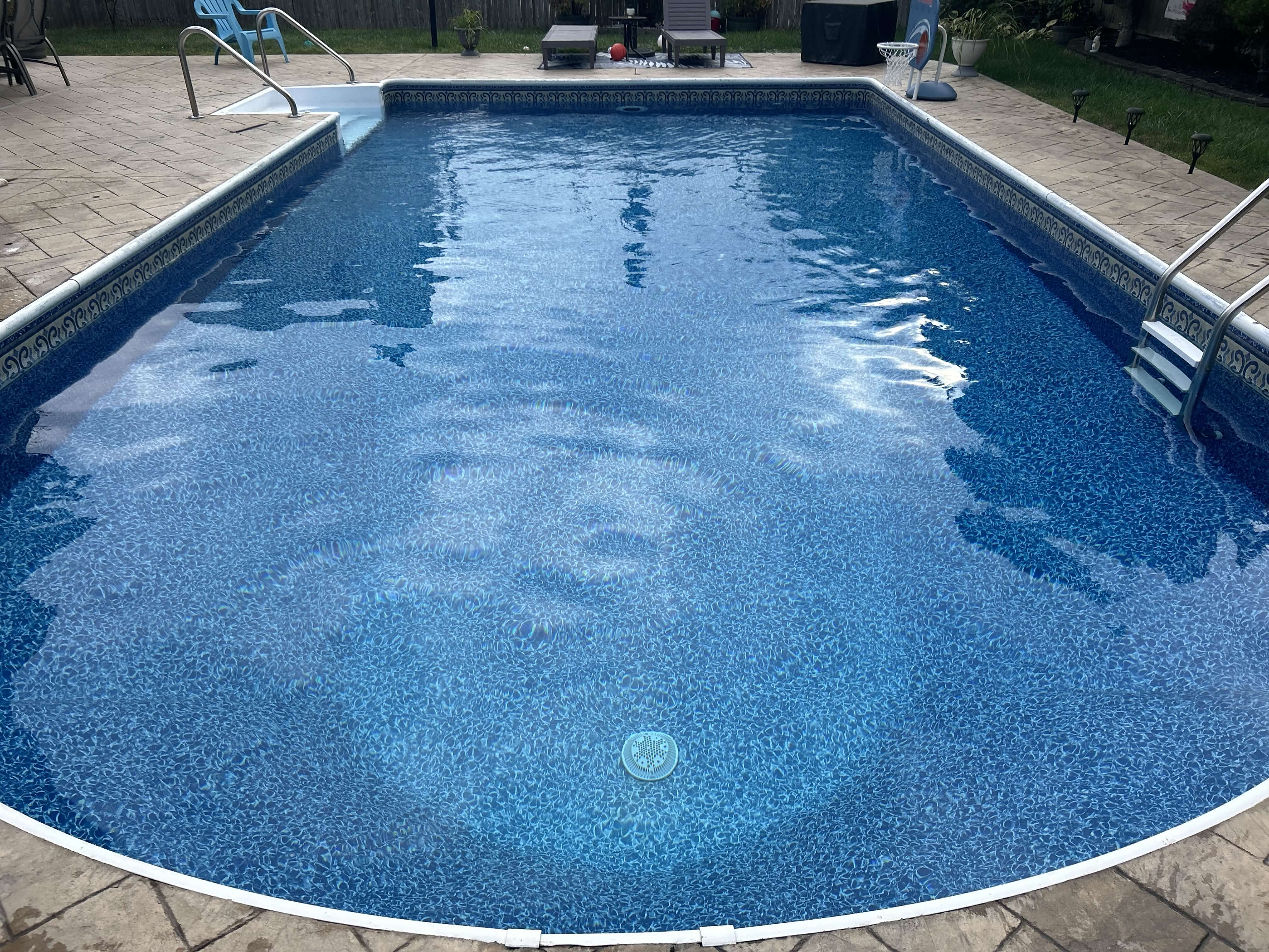 Clean inground pool after weekly maintenance service