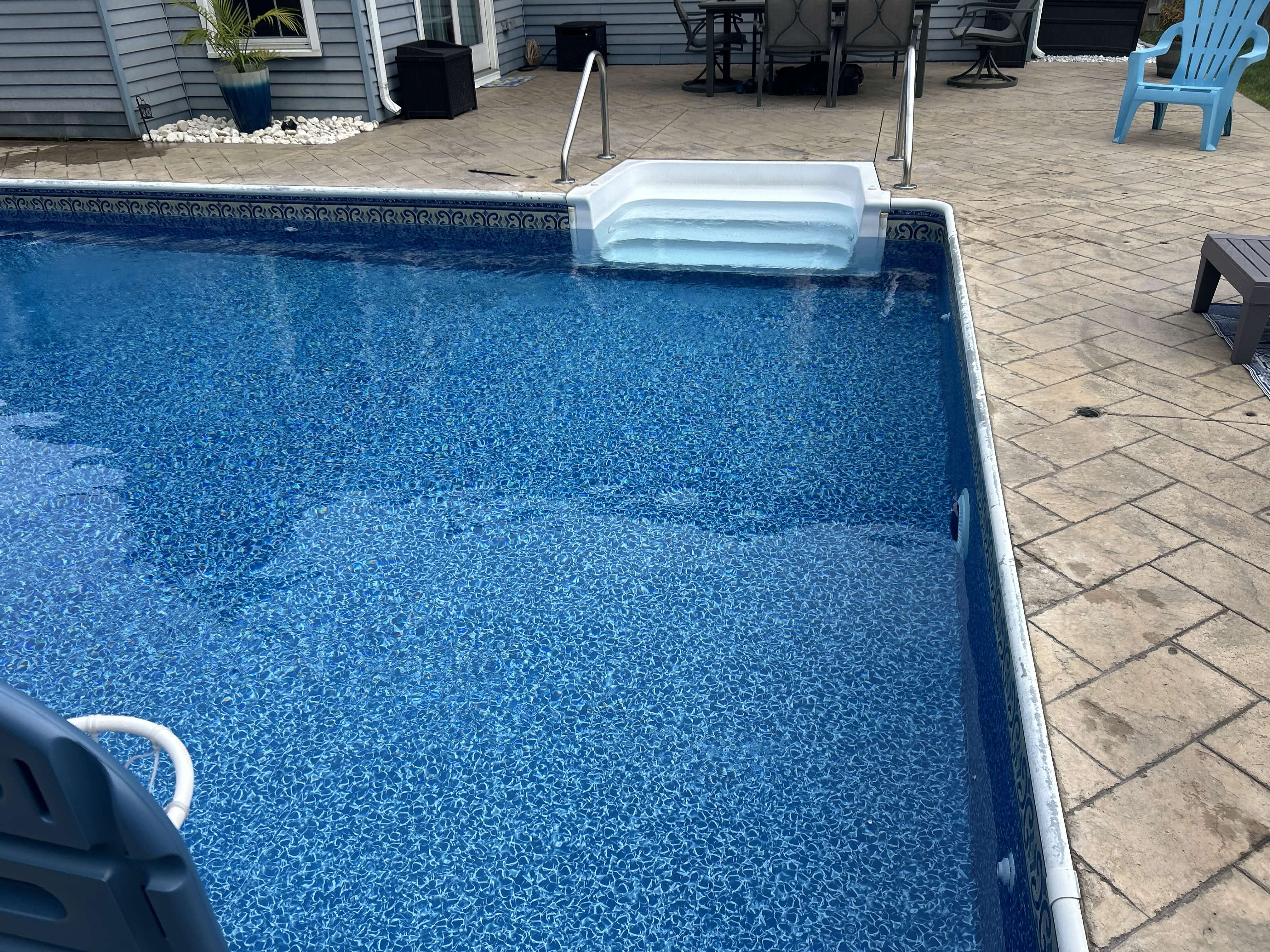 Crystal clear inground pool after weekly maintenance service