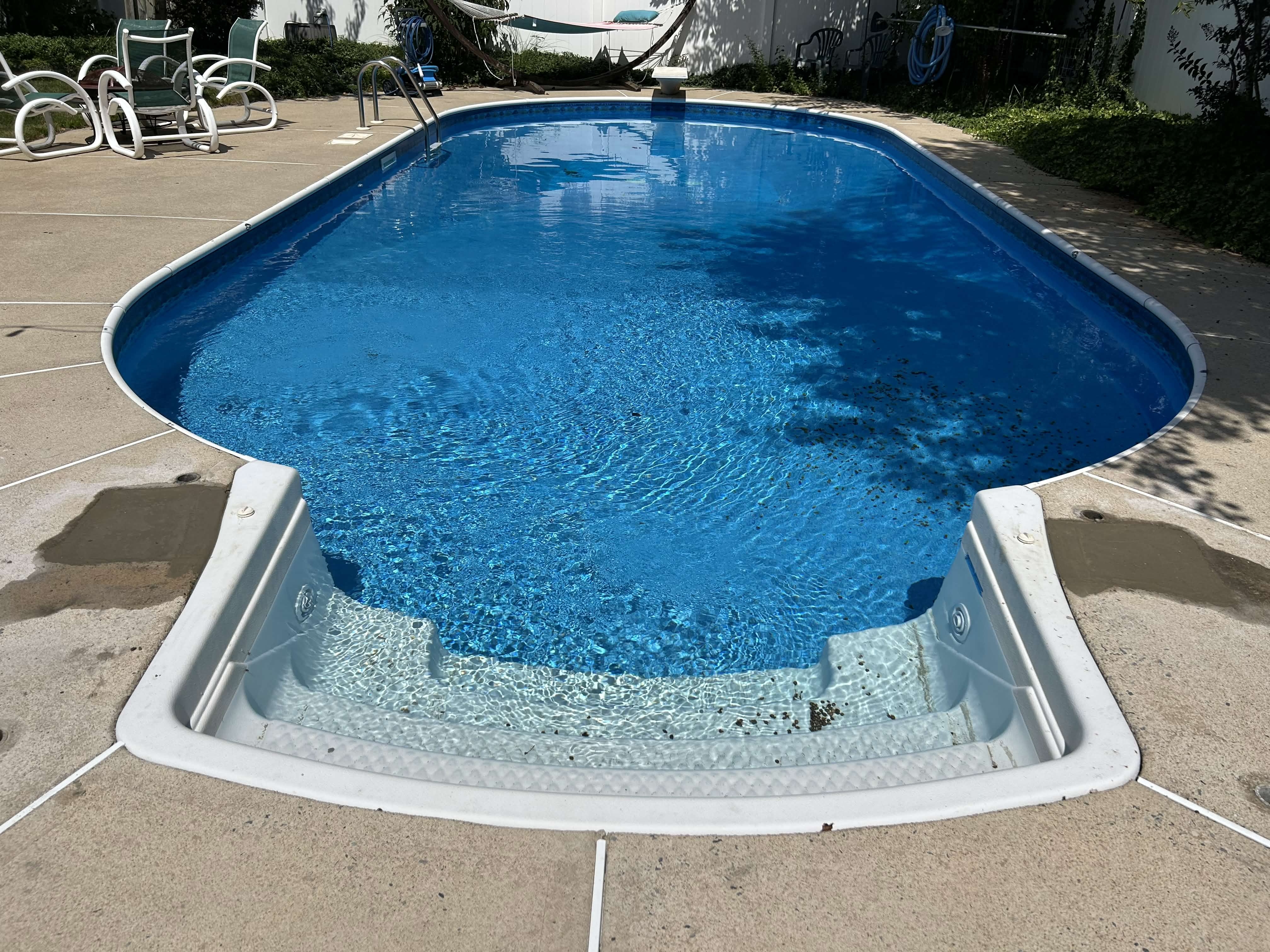 Clean oval inground pool ready for swim season