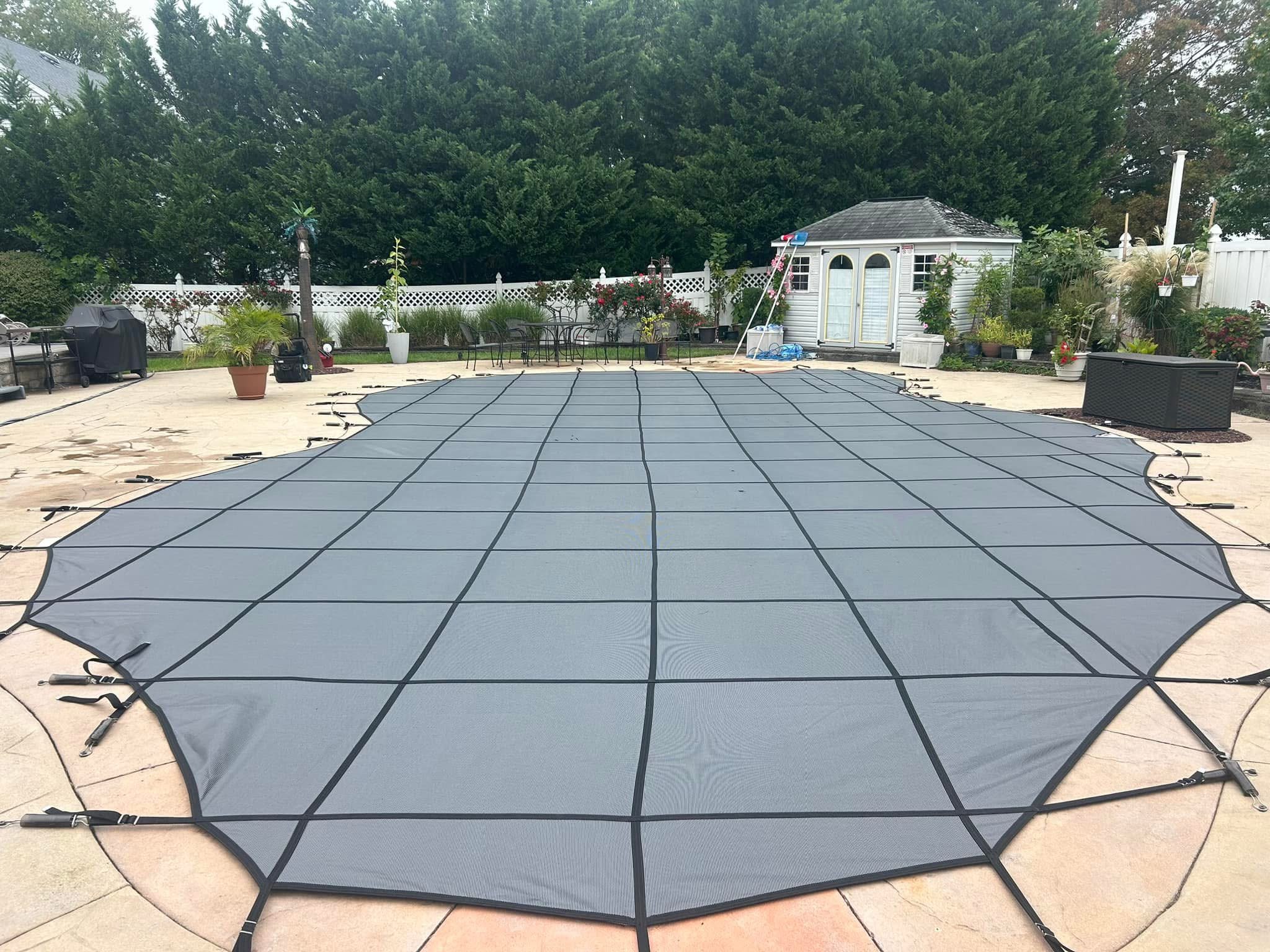 Custom-fit safety cover on freeform pool with gazebo
