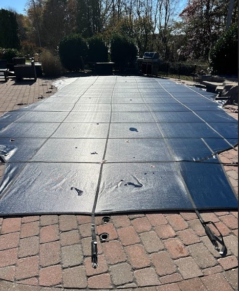 Professional safety cover securely installed over pool